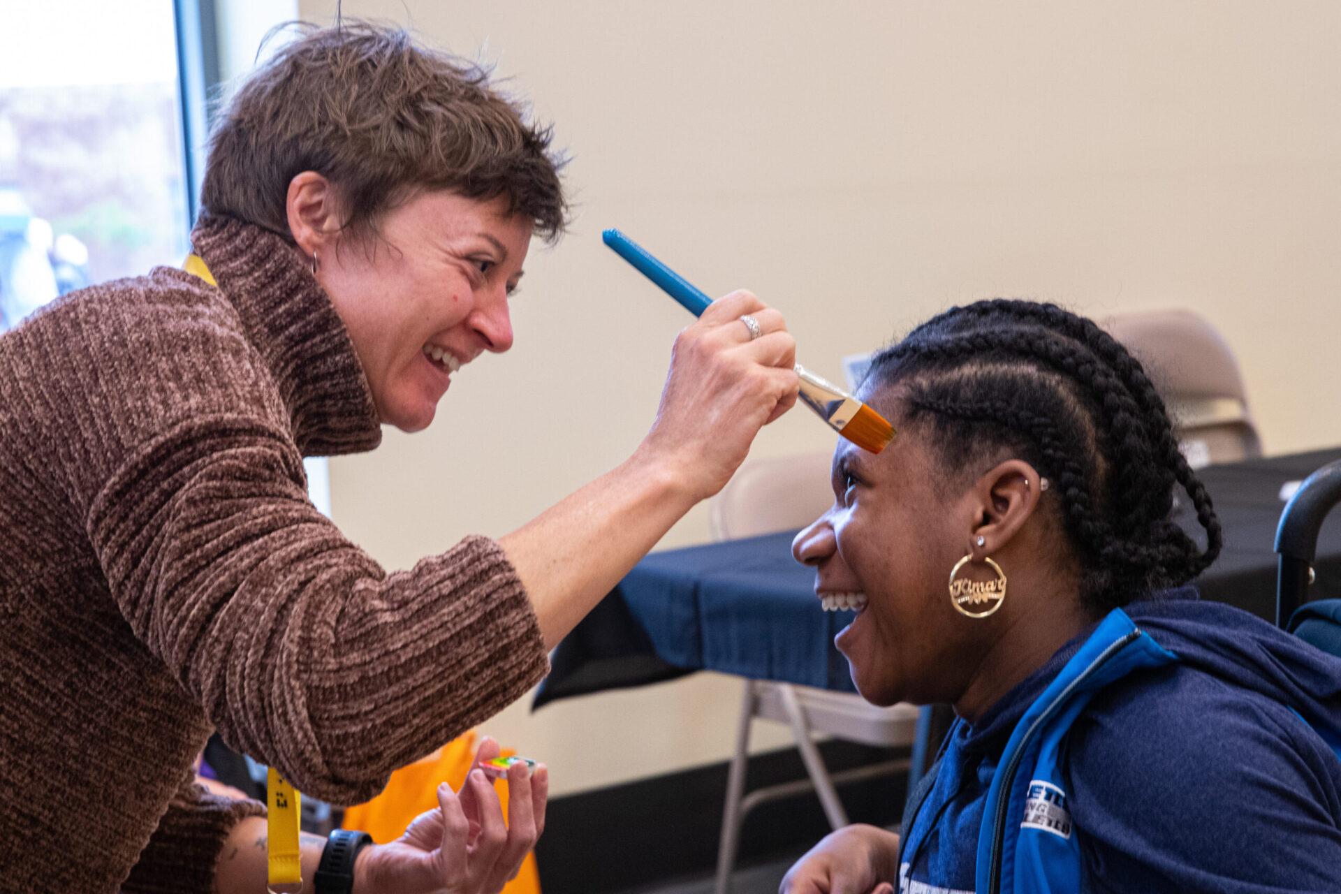 a woman is getting her hair cut by a woman.